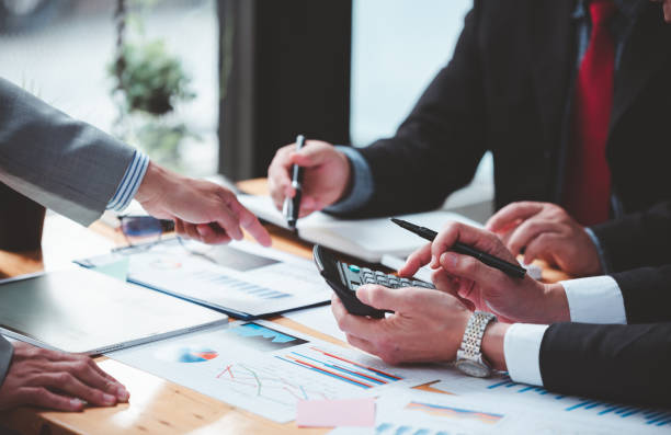 istock Businessmen meeting together, thinking, analyzing projects at the office. 1365567755