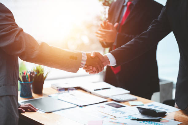 istock Businessmen shake hands to congratulate each other after discussing the contract. 1365567779