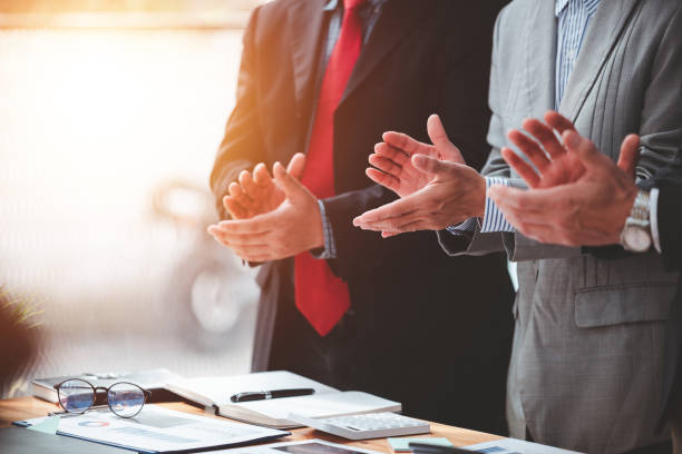 istock Businessmen applaud, congratulating the successful project. 1365567844