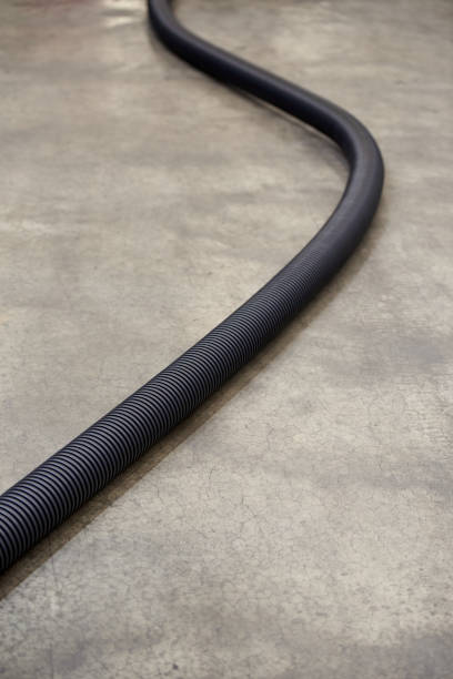 istock Corrugated plastic pipe for insulating electrical wires, on a concrete floor 1365569167