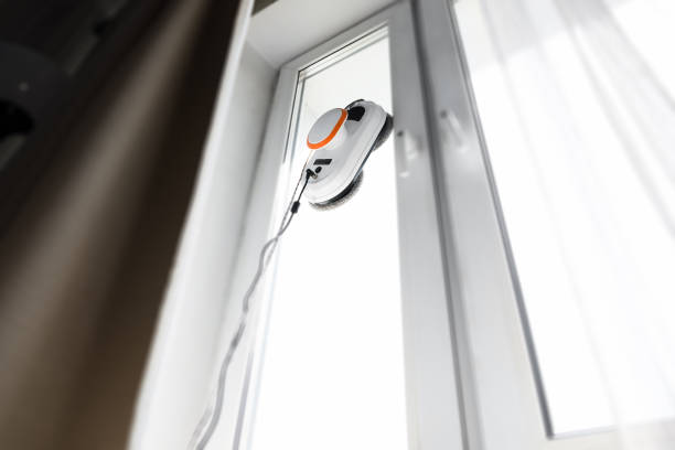 istock Robot window cleaner work on dirty window. Cleaning the house with smart devices. Automatic vacuum robots for cleaning windows, an assistant for the home 1365569300