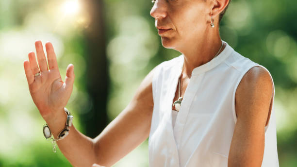 istock Woman Practicing Qi Gong in a Forest 1365572190