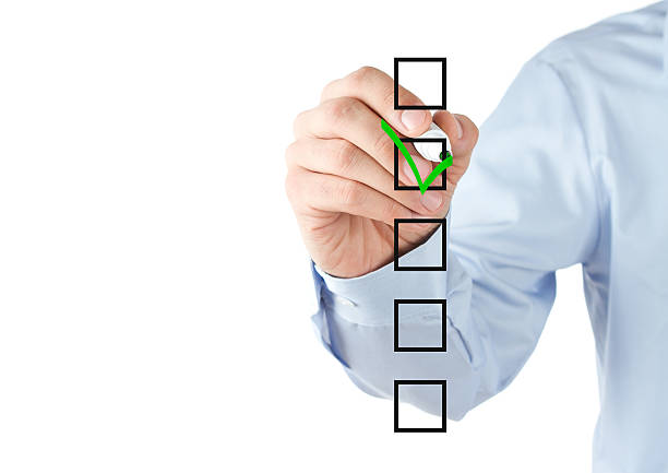 istock Person in blue shirt checking a list 136557258