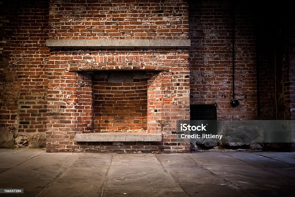 Brick wall and fireplace Background image of a brick wall and fireplace in a vacant setting. Fireplace Stock Photo