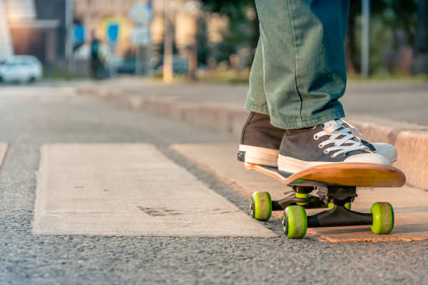 istock Close-up of men's legs on a skateboard 1365574471