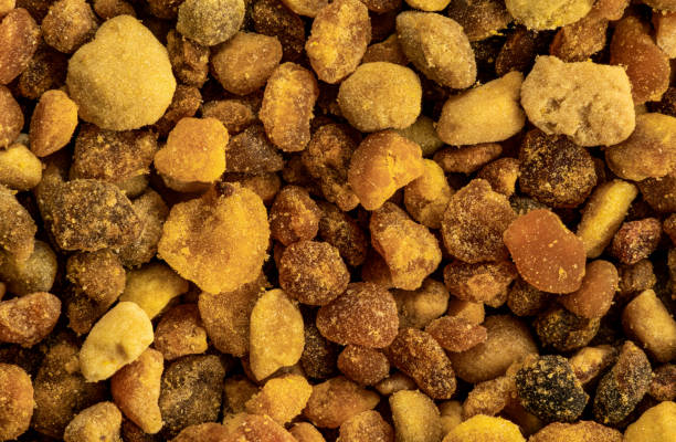 Bee pollen blobs or granules, individual spheres visible. 1.5x magnification, image width 23mm stock photo