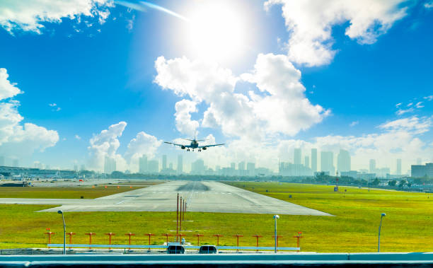 Airplane landing in Fort Lauderdale airport under a shining sun stock photo
