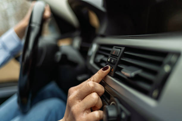 istock Woman regulates ventilation in her car. 1365576481
