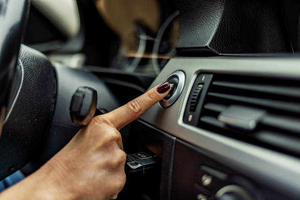 dito della donna che preme il pulsante di avvio / arresto del motore sull'auto - accensione foto e immagini stock