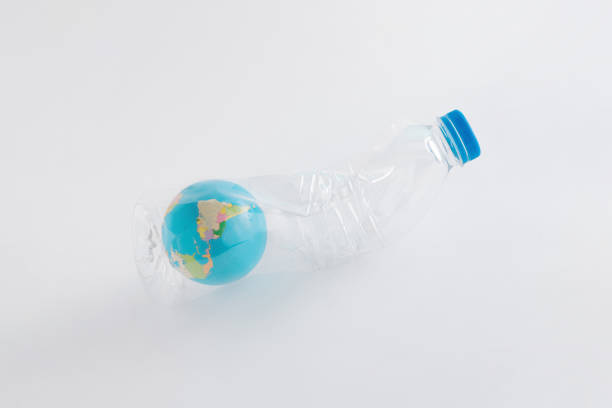 istock 2022. Globe trapped in a crumpled plastic bottle on a pastel white isolated background. The dystopian future of planet Earth. Minimal creative ecological concept of global nature pollution. Save the World. 1365579398