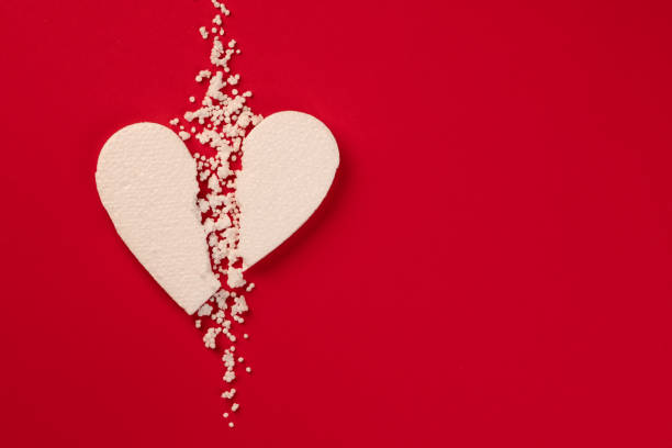 istock Background with white broken styrfoam heart on a red backdrop 1365580259