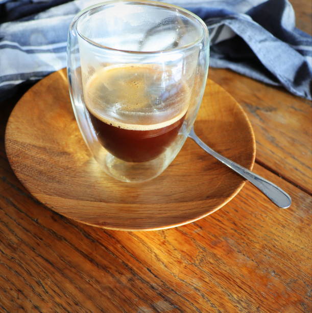 istock Transparent double wall glass mug with espresso coffee on rustic wooden background 1365580309