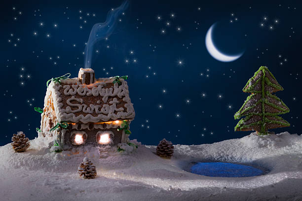 Gingerbread lodge with light from the window in winter