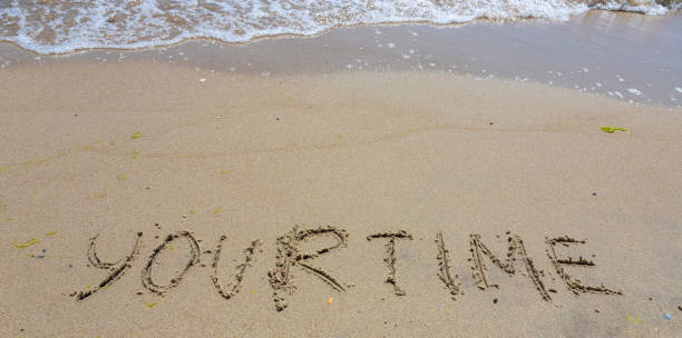 istock Handwriting word your time written in the sand 1365584932