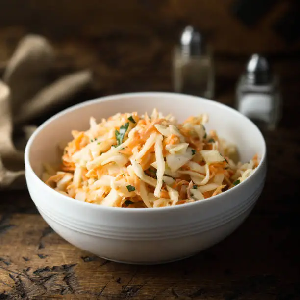 Traditional homemade coleslaw salad with fresh parsley