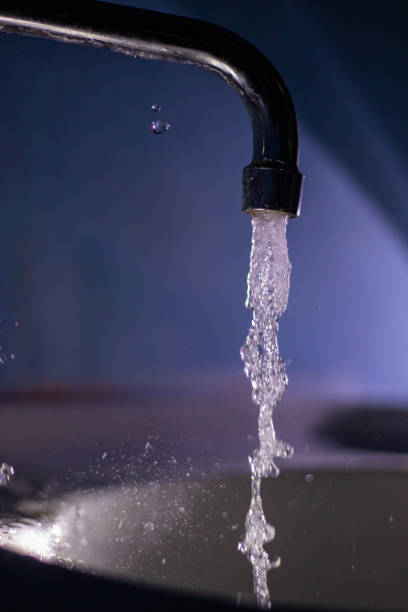 istock working water tap, running water faucet. close-up 1365586091