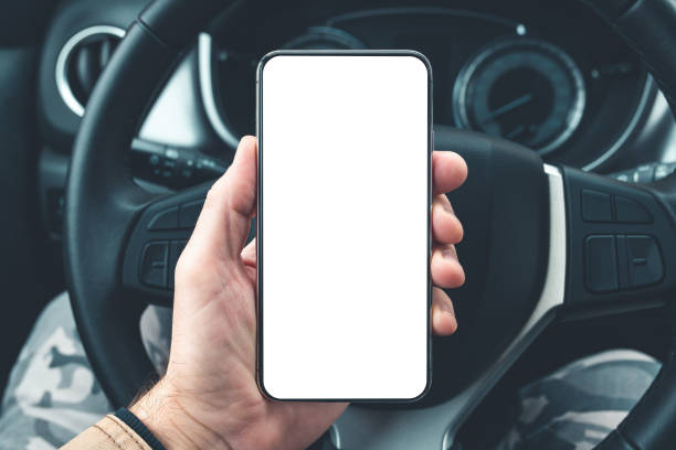 istock Smartphone mockup in male driver hand over car steering wheel 1365586449