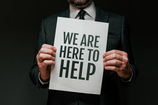 istock We Are Here To Help, message on poster paper. Business consultant and advisor posing. 1365586456