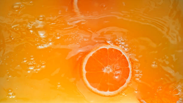 istock Full frame of orange juice with orange slice 1365587137
