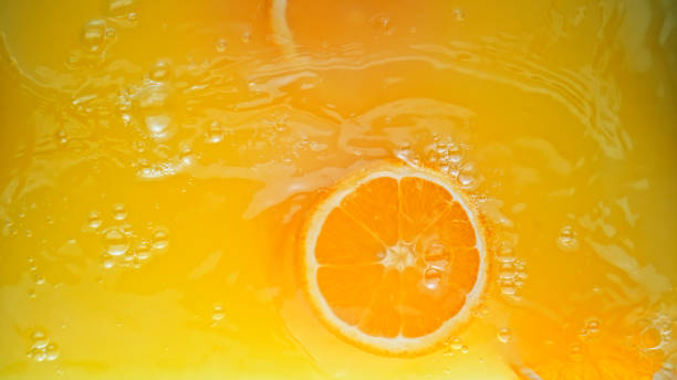 istock Full frame of orange juice with orange slice 1365587146