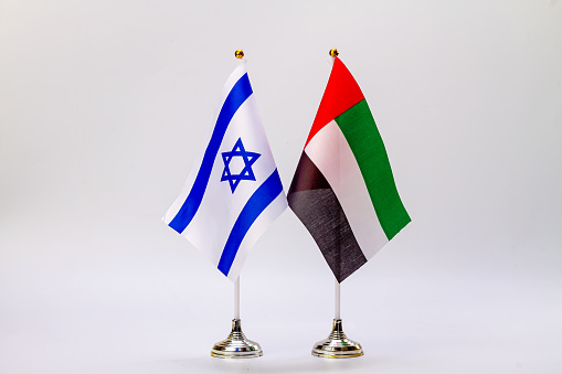 The national flags of Israel and the United Arab Emirates on a light background.