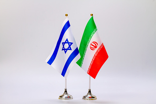 State flags of Israel and Iran on a light background.