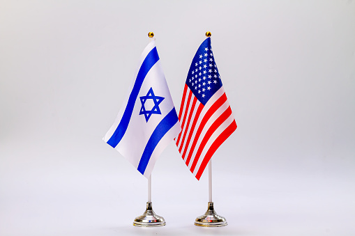 State flags of Israel and the USA on a light background.