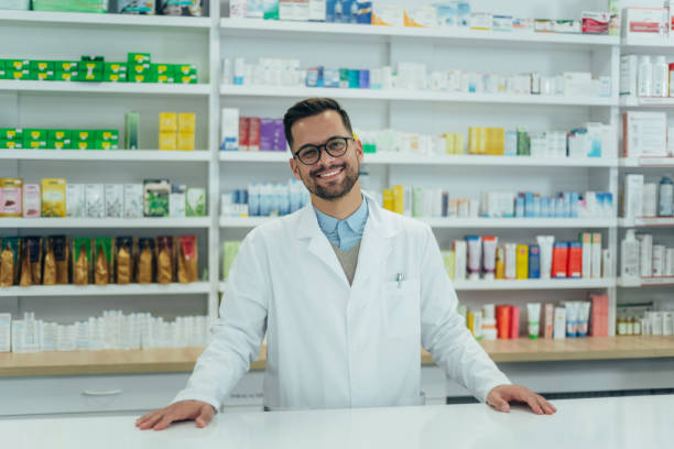 istock Portrait of a handsome pharmacist working in a pharmacy 1365590305