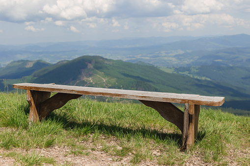 Bench on the edge of the hill in the park. Carpathian mountains, Ukraine, Europe. Discover the beauty of earth.