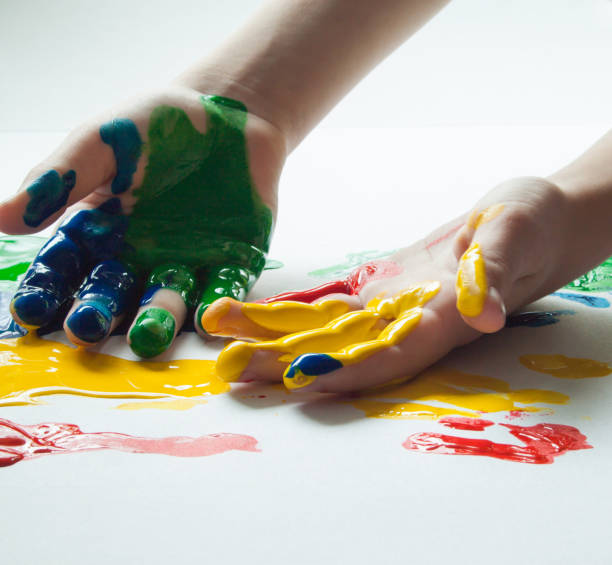 istock Children's hands in colorful paints. 1365590738