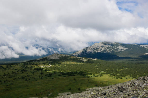 istock Beautiful panoramic view on the clouds in mountain valley 1365591056