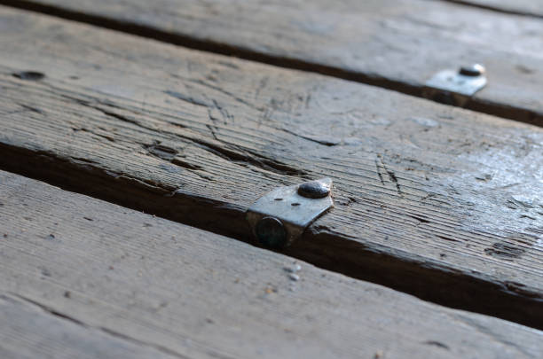 istock Old numbered boards. Repeated floorboards with nailed aluminum t 1365591739