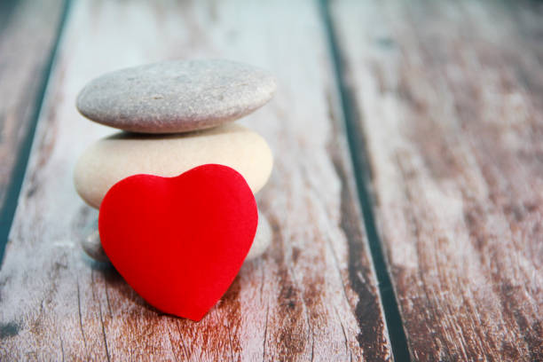 istock red heart on gray stones 1365593840