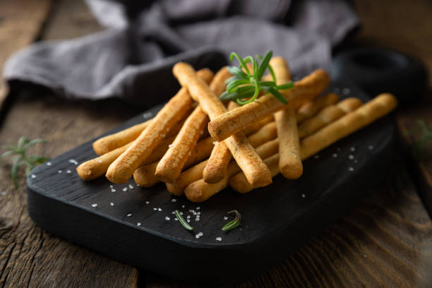 Crispy bread sticks with salt and rosemary Crispy bread sticks with salt and rosemary breadstick stock pictures, royalty-free photos & images