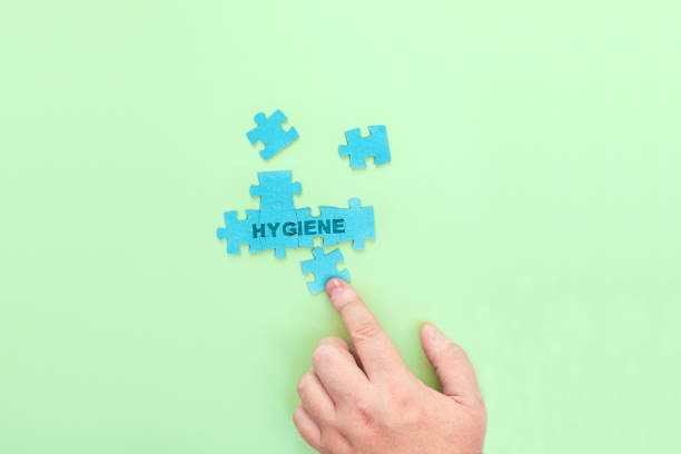 istock A man connecting the puzzle pieces with the word Hygiene 1365595792