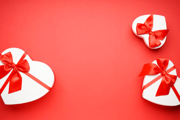 istock Gift boxes for Valentine's Day on red background with space for text 1365596221
