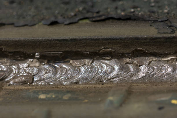istock Low angle close up of overlapping weld marks on steel 1365597195