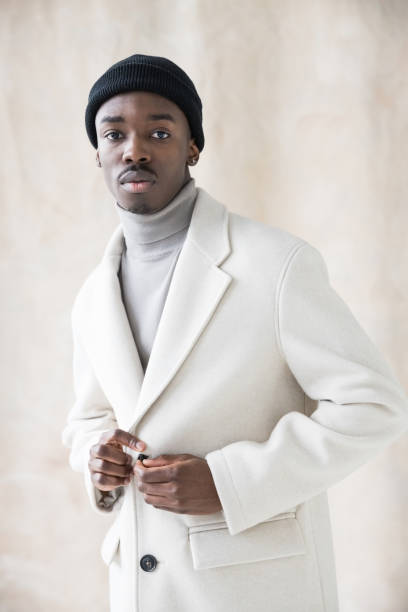istock Elegant young man wearing white coat 1365598701