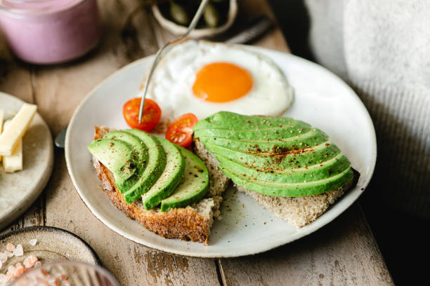 istock Close-up of an avocado toast with fried egg  in a plate 1365598918