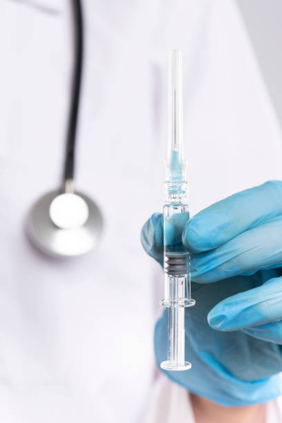 istock Doctor hands with blue gloves 1365599050