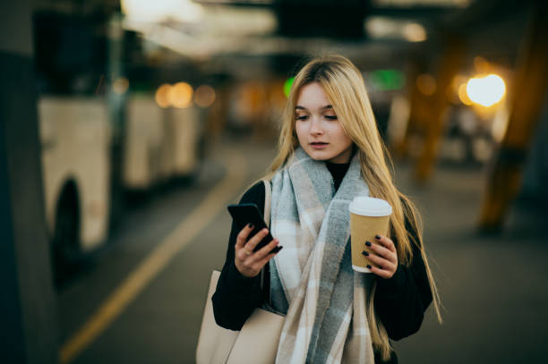istock Young woman waiting at a bus stop 1365599693