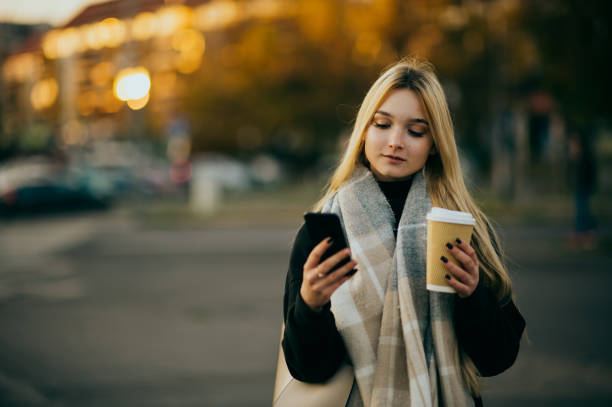 istock Young woman waiting at a bus stop 1365599695