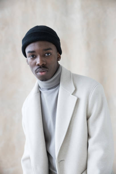 istock Elegant young man wearing white winter coat 1365599827