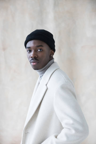 istock Elegant young man wearing white winter coat 1365601115