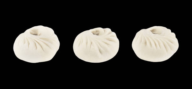 national Mongolian Chinese food dumpling Buuz filled with minced beef, isolation on a black background.