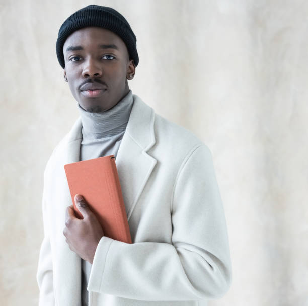 istock Elegant young man wearing white winter coat 1365601776
