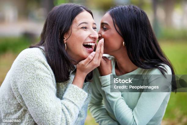 Shot Of Two Young Women Telling Secrets Outside At College Stock Photo - Download Image Now