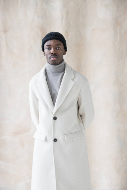 istock Elegant young man wearing white winter coat 1365601936