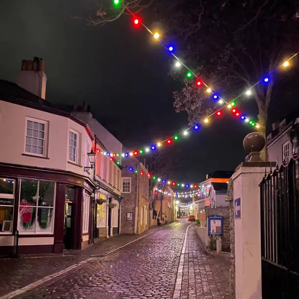 Cobbled street and Christmas lights of St Anne in Victoria Street in Alderney, Channel Islands