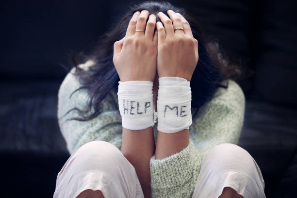 Shot of a young woman with bandages wrapped around her wrists showing “help” written on them You are not the storm that rages inside you self harm photos stock pictures, royalty-free photos & images